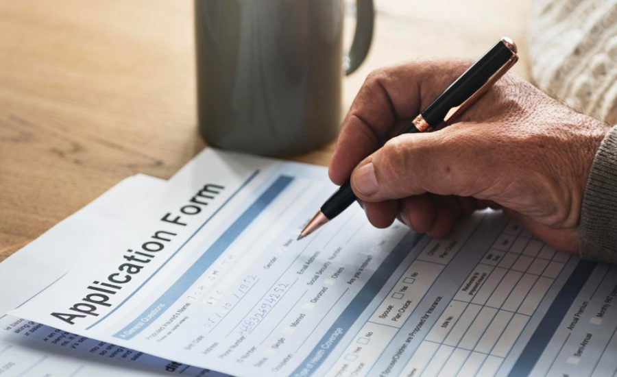 pensioner-filling-out-aform-900x550